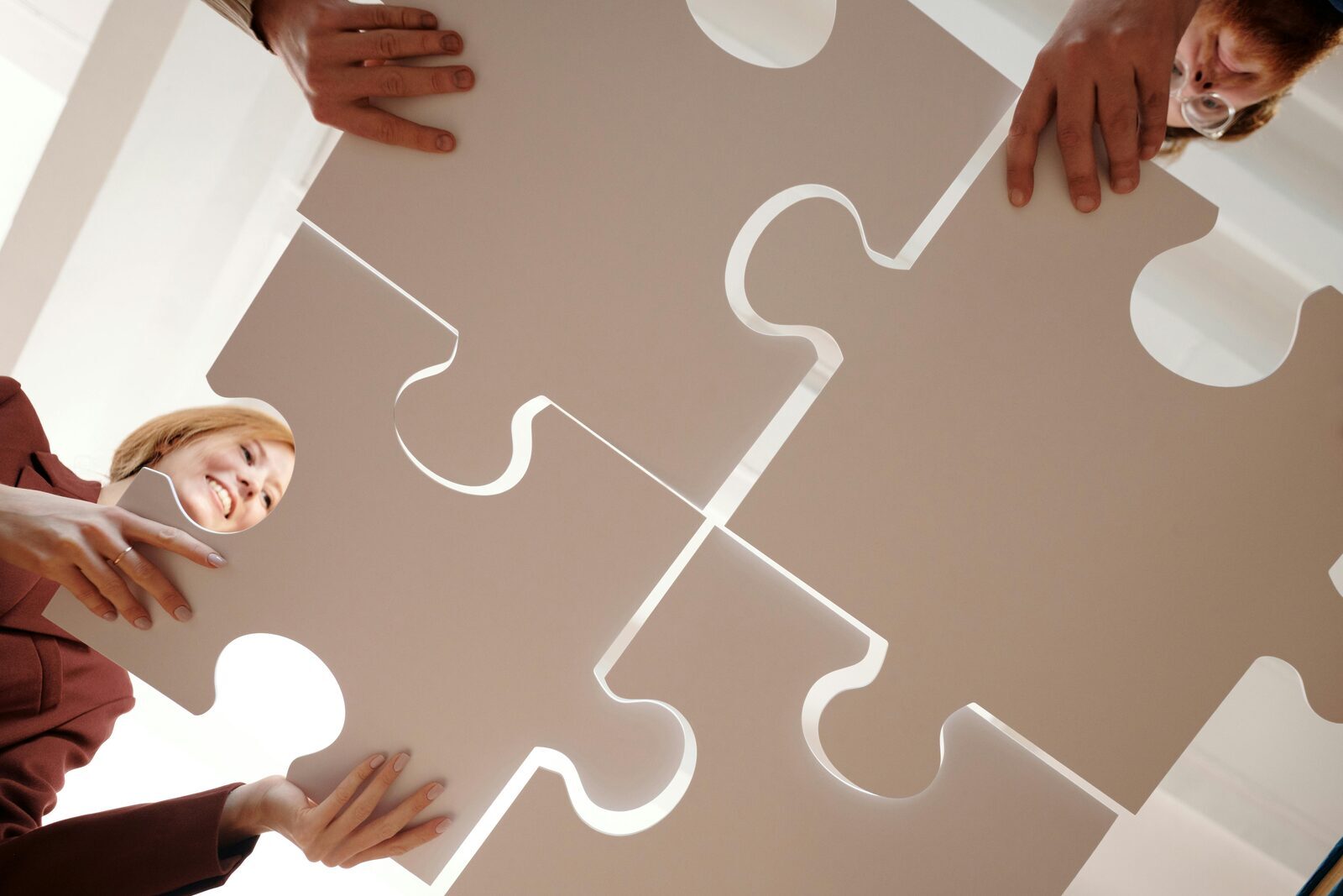 Business professionals in a meeting, shaking hands over documents
